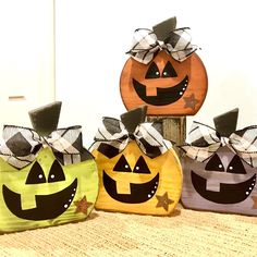 three pumpkin bags with faces painted on them