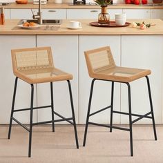 two stools sitting in front of a kitchen counter