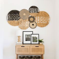 a wooden table topped with baskets and pictures