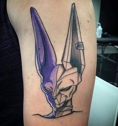 a tattoo with an origami mask on it