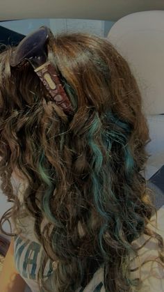 blue green highlights light brown caramel curly wavy hair Emerald Green And Brown Hair, Dyed Highlights Curly Hair, Colorful Hair Dye Ideas For Brunettes, Brown Curly Hair With Blue Highlights, Brown And Blue Curly Hair, Curly Hair With Blue Streaks, Brown Hair Teal Highlights, Blue Streaks Curly Hair, Curly Dyed Hair Highlights