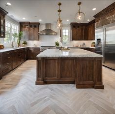 a large kitchen with wooden cabinets and marble counter tops, along with stainless steel appliances