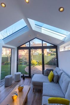 a living room filled with furniture under a skylight