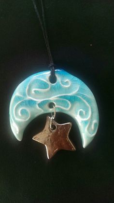 a blue and white pendant with a star on it