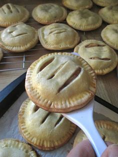 a person is spooning out some pie crusts