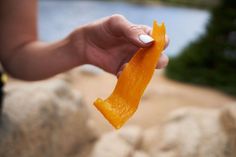 a person holding an orange peel in their hand