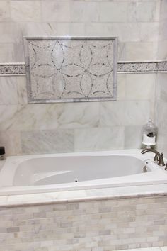 a white bath tub sitting inside of a bathroom