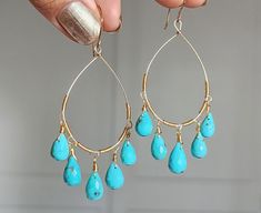 These majestic pieces are inspired by the natural changing of the seasons, the turquoise and deep yellow of the gold combine for a soothing summer feeling. Each earring features gold-fill wire delicately wrapped around a hoop, allowing the precious micro-faceted turquoise drops to hang naturally and sway with movement. Turquoise is a classic gemstone, easily recognisable and we ensure that we source only the finest AAA+ quality Arizona Turquoise. 💜 G E M S T O N E S 💜 * Gemstone: Natural Turqu Turquoise Chandelier, Turquoise Hoop Earrings, Turquoise Hoops, Deep Yellow, Arizona Turquoise, Earrings Turquoise, Summer Feeling, Velvet Bag, Gift Jewelry