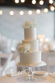 a white wedding cake sitting on top of a table