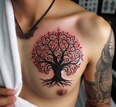 a man with a tree tattoo on his chest holding a white towel over his shoulder