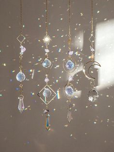 the sun shines through the window and reflects on the wall with many different jewels hanging from it