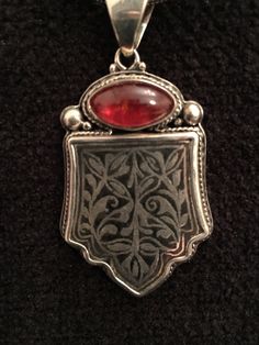 "Artist: John Binzley Rubellite Tourmaline Cabochon Sterling Silver Bezel and Bali Sterling Silver Solid Back Length: 2 1/8\" Width: 1 1/4\" Stainless Steel Snake Chain 20\" Traditional Inlay Sterling Silver Wire Inlay swirl and floral motifs. Signed By The Artist: John Binzley Any metal can be inlaid into another, but the difficulty of the procedure and the results can vary depending on the hardness of the metals used. The history of inlay is very old. The technique of metal in metal inlay was Statement Piece Jewelry, Rubellite Tourmaline, Pacific Grove, Beaded Handbag, Pendent Necklace, Bead Leather, Gems Jewelry, Floral Motifs, Silver Wire