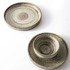 two bowls sitting next to each other on a white surface