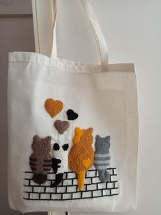 a tote bag with cats and hearts on it