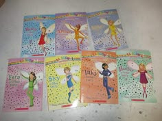 six children's books with tinkerbells on them