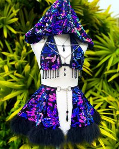 a mannequin wearing a purple and blue outfit with black fur trimmings