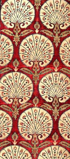 a red and white rug with an intricate design