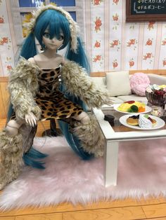 a doll sitting on top of a table in front of a white couch with blue hair