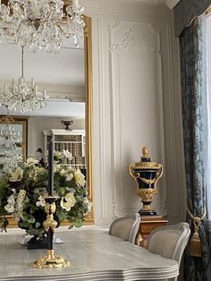 a dining room table with chairs and a chandelier