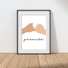 two hands holding each other with the word paradise in black and white framed on a wall