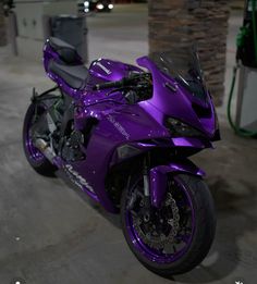 a purple motorcycle is parked in a garage