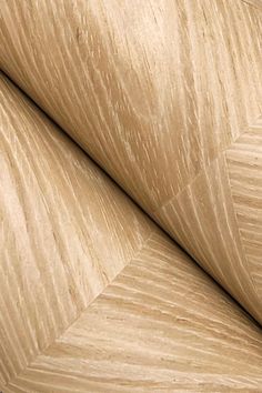 a close up view of the wood grains on a wallpapered material background