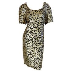 Fabulous 1980s vintage OLEG CASSINI fully sequined leopard print short sleeve silk dress ! Features thousands of hand-sewn gold and black sequins throughout the entire dress. Hidden zipper up the back with hook-and-eye closure. Great belted or alone. The pictured 90s Jane August black patent croc embossed belt is also available in my 1stDibs Shop. In great condition US Size 12 / 14 Measurements: 40 inch bust 34 inch waist 40 inch hips 38.5 inches from top back shoulder seam to hem Leopard Print Short Sleeve Party Dress, Satin Leopard Dress, Short Sleeve Leopard Print Party Dress, Elegant Knee-length Leopard Print Dress, Casual Leopard Print Knee-length Dress, Knee-length Leopard Print Party Dresses, Oleg Cassini, Leopard Print Shorts, Chic Leopard Print V-neck Mini Dress