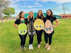 three girls are standing in the grass with their costumes made to look like cartoon characters