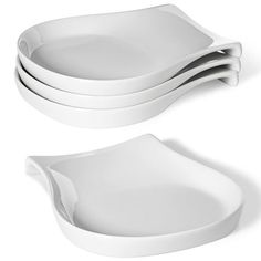 three white dishes stacked on top of each other in the shape of an oval dish