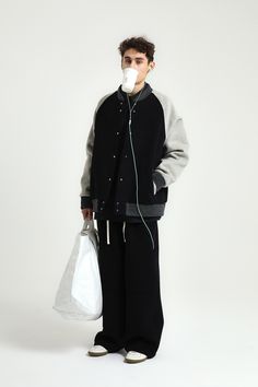 a young man with an oxygen tube in his mouth is standing against a white background