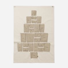 a piece of cloth hanging on the wall with squares and numbers printed on it in white