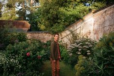 a man standing in the middle of a garden