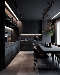 a dining room table with chairs and lights on the ceiling is surrounded by black cabinets