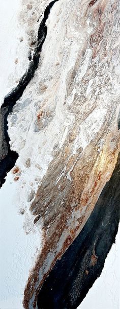 a snowboarder is going down a snowy hill