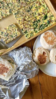 several different types of food are on plates and in pans next to each other