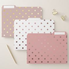 three pink and gold polka dot file folders next to a pair of pencils