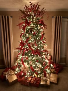 a decorated christmas tree with presents under it