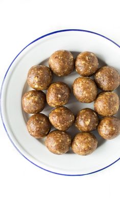 a white plate topped with meatballs on top of a table