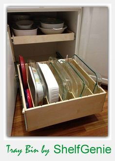 an open drawer with dishes in it