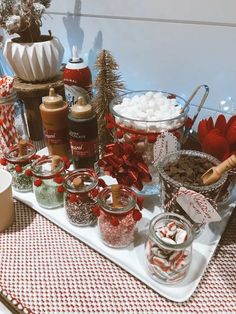 an assortment of candy and candies on a tray with christmas decorations in the background