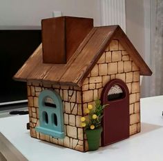 a small toy house sitting on top of a table