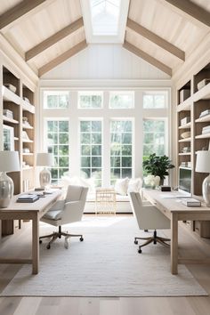 a living room filled with lots of furniture and bookshelves next to a window