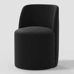 a black chair sitting on top of a white floor