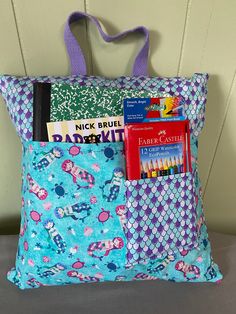 a blue bag with books and pencils in it