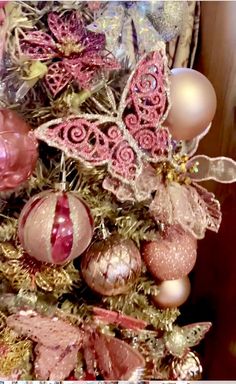 a decorated christmas tree with pink and gold ornaments