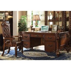 an ornate desk and chair in a living room