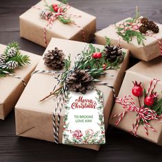 several wrapped presents with pine cones, cinnamon sticks and evergreen needles tied to them on a wooden table