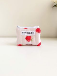 Our small quilted makeup pouch is handmade using cotton fabric.  It offers function and style and fits perfectly in your handbag while you're on the go. We recommend using it for makeup, coins and business cards and other small accessories. Featuring red strawberries on pink cotton fabric, white zipper pull and beige cotton lining. It is perfect for travel and everyday use. Dimensions of product  11cm width x 9cm height Care instructions Hand wash recommended Pink Quilted Bag For Gift, Quilted Pouch Cosmetic Bag Gift, Quilted Cosmetic Pouch Bag As Gift, Quilted Pouch Cosmetic Bag As Gift, Quilted Pouch Cosmetic Bag, Quilted Pouch Bag For Gift, Quilted Pouch Bag As Gift, Fabric Bags With Zipper Pouch For Gift, Fabric Bags With Zipper Pouch As Gift