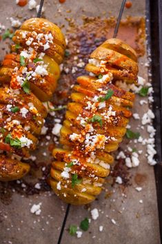 several grilled bananas on a tray with parmesan cheese and seasoning sprinkles