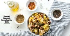 a bowl filled with vegetables next to two bowls of seasoning